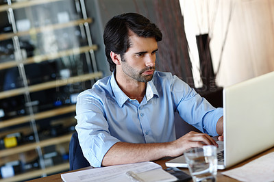 Buy stock photo A young businessman typing out a brief for a client
