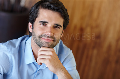 Buy stock photo Smiling businessman with his hand on his chin