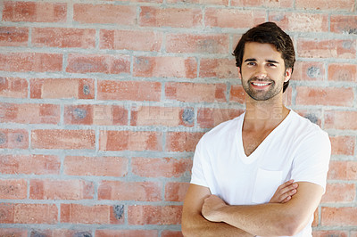Buy stock photo Man endorsing marketing, advertisement, promotion while standing alone with  arms crossed and isolated against red brick wall background with copy space. Copyspace for sales deal, discount or bargain