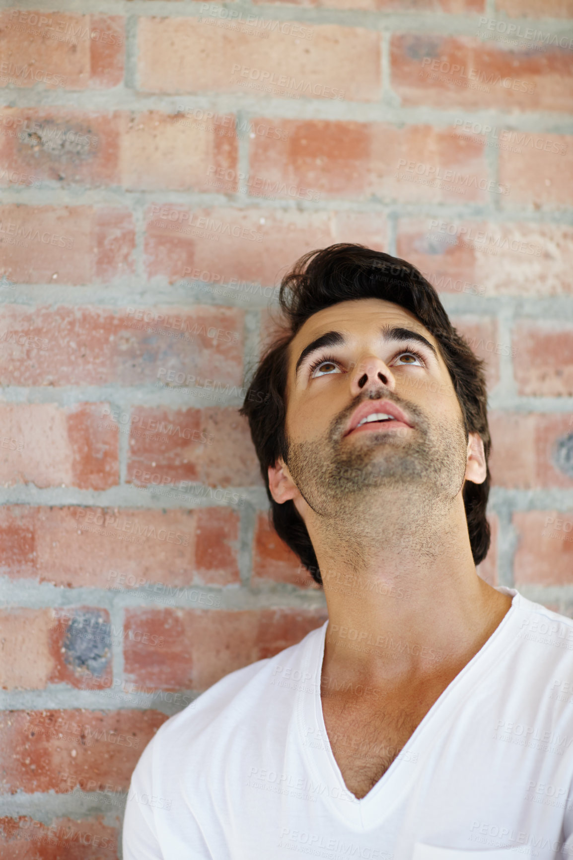 Buy stock photo Man, thinking and face looking up against brick wall at work with idea, vision and contemplating in office. Expression, dreaming or thoughtful worker with memory, pensive choice and remembering plans