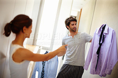 Buy stock photo Handsome man asking his wife what he should wear