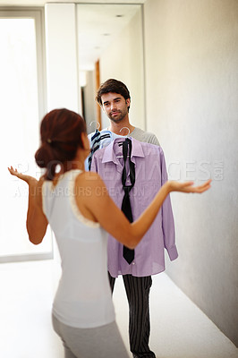 Buy stock photo Handsome man asking his wife what he should wear