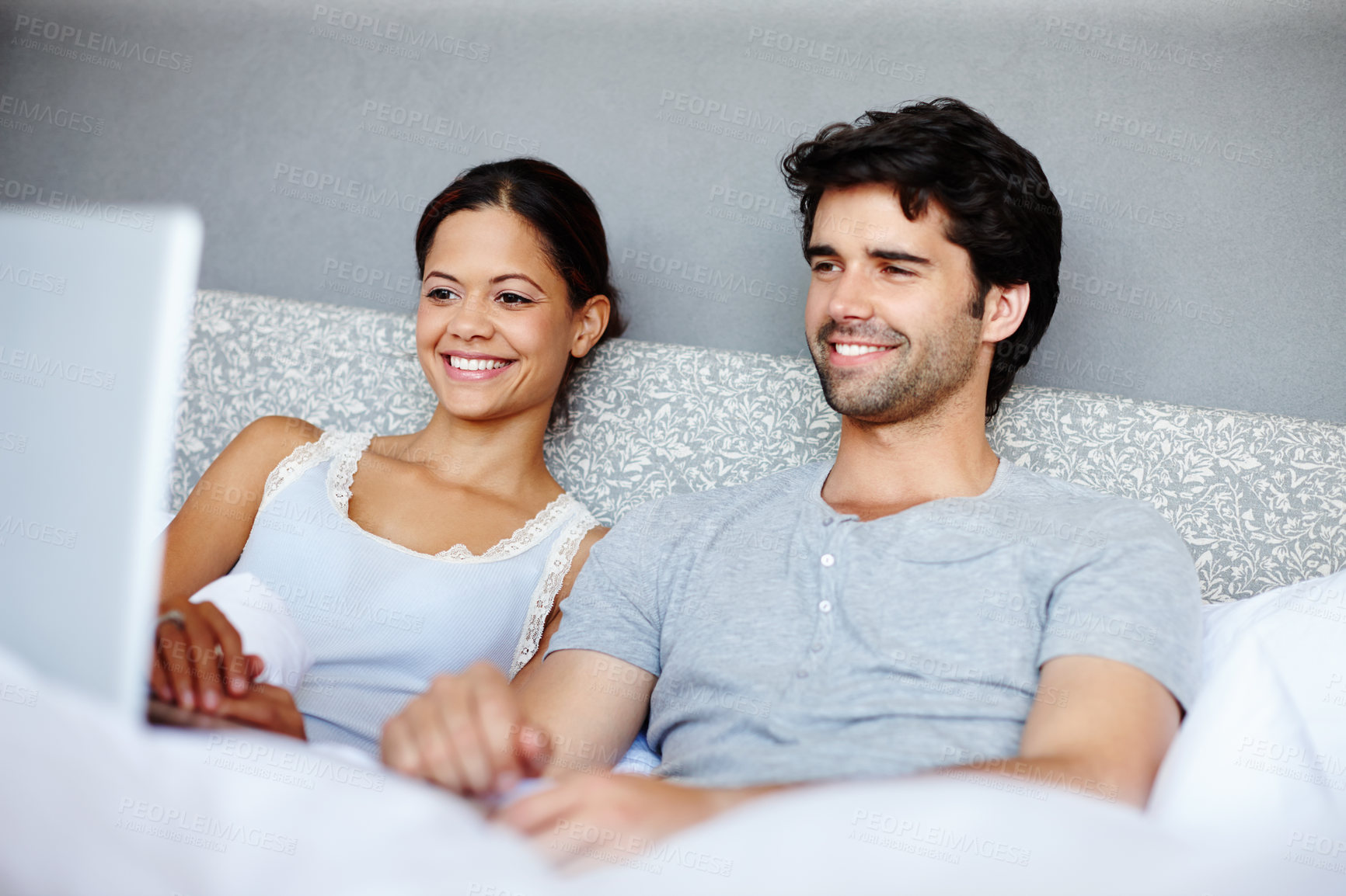 Buy stock photo Happy couple, relax and watching with laptop in bed for online streaming, subscription or movie at home. Man and woman with smile together for morning, show or series on computer in bedroom at house
