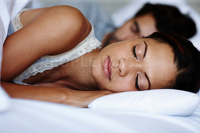 Buy stock photo Cute young couple sleeping in bed together