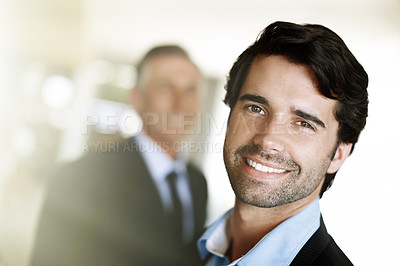 Buy stock photo Handsome young businessman looking at the camera 