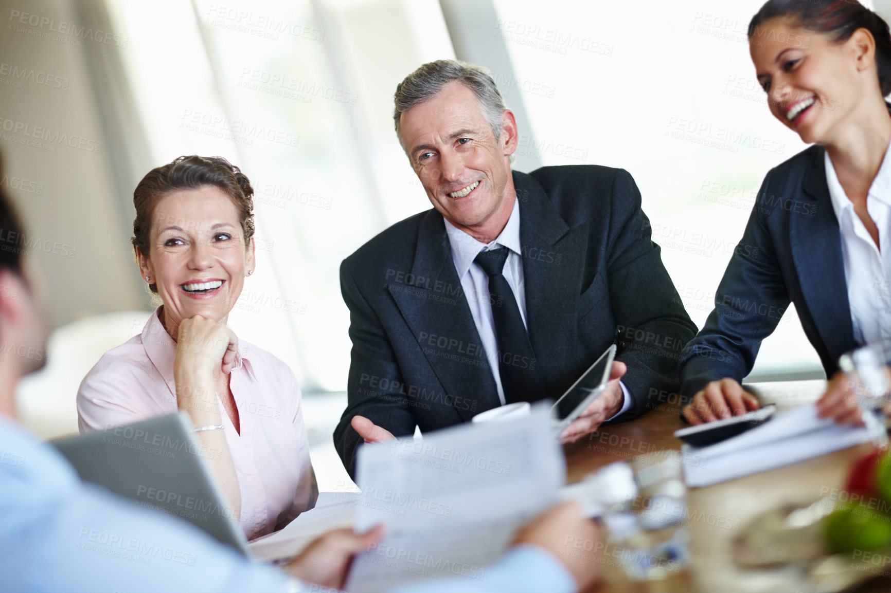 Buy stock photo A group of businesspeople having a meeting and discussing business