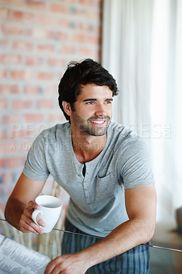 Buy stock photo Shot of a man holding his coffee and newspaper