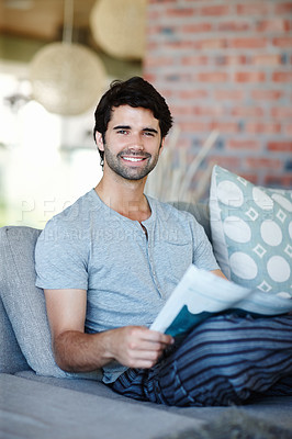 Buy stock photo Portrait, man and newspaper on couch at home for information, story or news for reading. House, lounge and male reader with article on vacation, holiday and weekend trip in London to relax on sofa