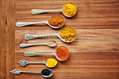 Buy stock photo Colour, curry and spices on vintage spoon with natural ingredients to cook dinner. Asian, power and seasonings for hot, spicy and delicious authentic Indian food with flavour on tabletop in kitchen 