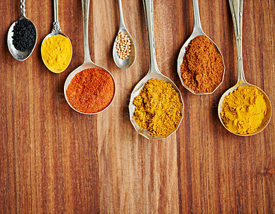 Buy stock photo Spoons, spice and selection of flavor for seasoning on kitchen table, turmeric and paprika for meal. Top view, condiments and options for spicy cooking in Indian culture, cumin and food preparation