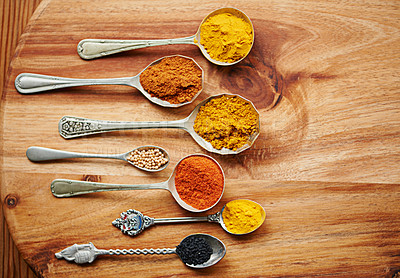 Buy stock photo Variety, curry and spices on vintage spoon with natural ingredients to cook dinner. Asian, power and seasonings for hot, spicy and delicious authentic Indian food with flavour on tabletop in kitchen 