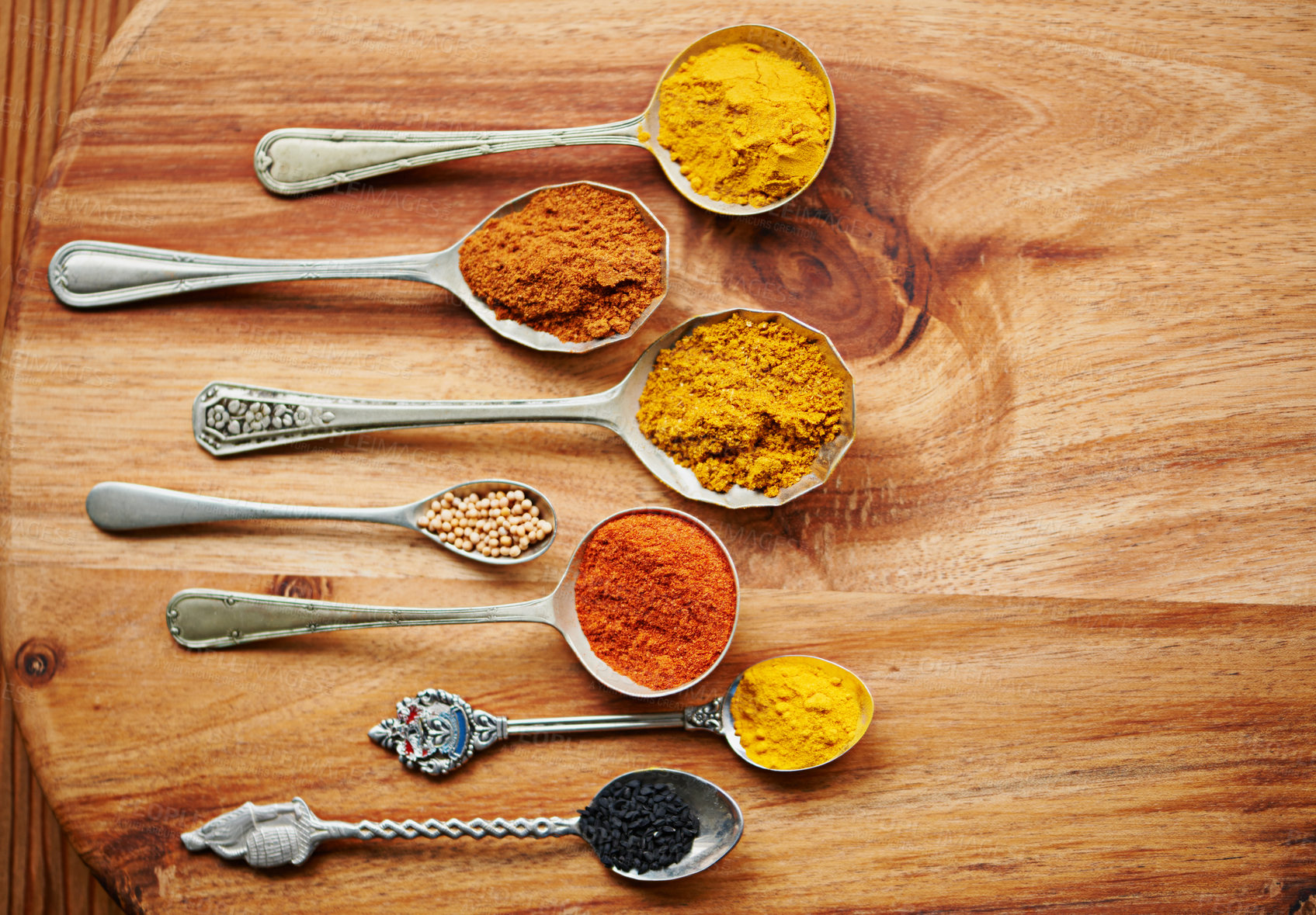 Buy stock photo Variety, curry and spices on vintage spoon with natural ingredients to cook dinner. Asian, power and seasonings for hot, spicy and delicious authentic Indian food with flavour on tabletop in kitchen 