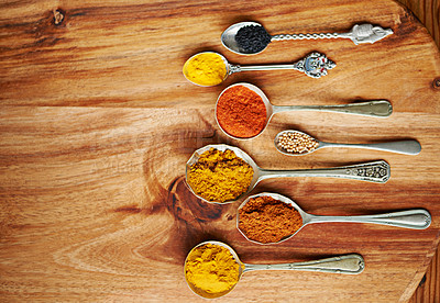 Buy stock photo Spoons, spice and selection of ingredients for seasoning on kitchen table, turmeric and paprika for meal. Top view, condiments and options for cooking in Indian culture, cumin and food preparation