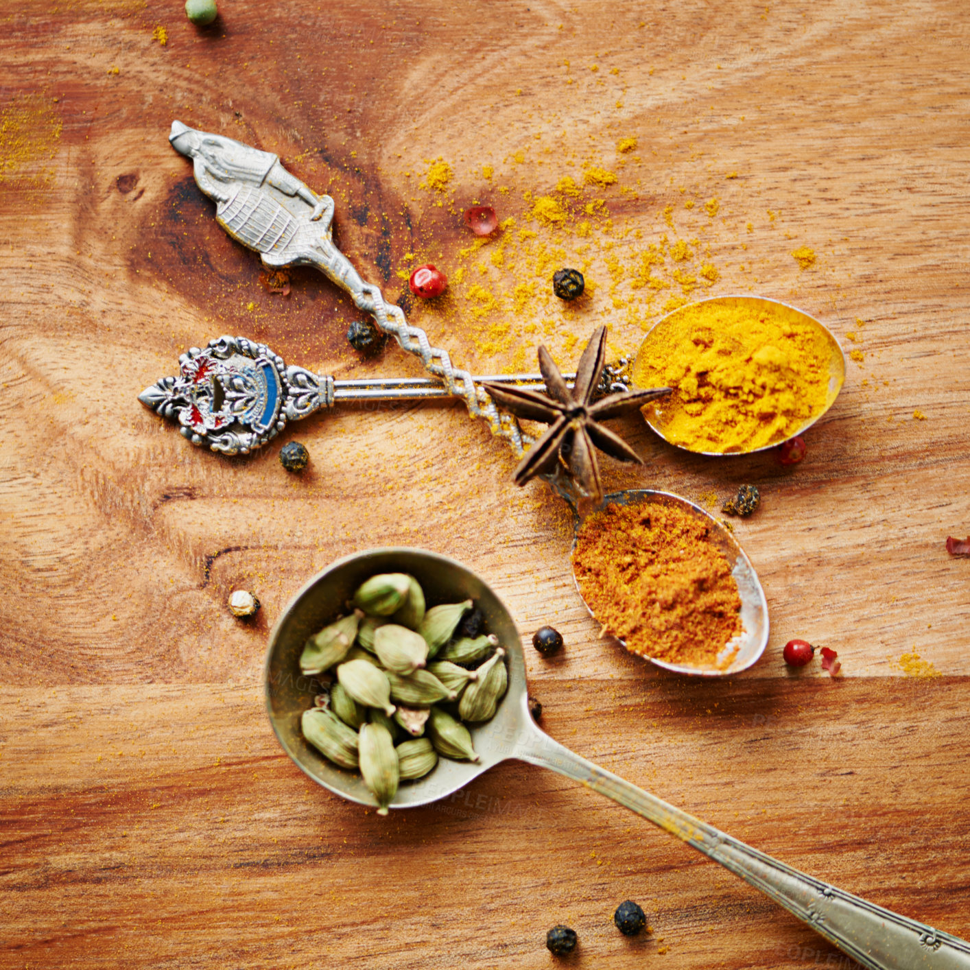 Buy stock photo Spoons, spice and selection of cuisine for seasoning on kitchen table, turmeric and cardamom for meal. Top view, condiments and options for spicy cooking in Indian culture, cumin and food preparation