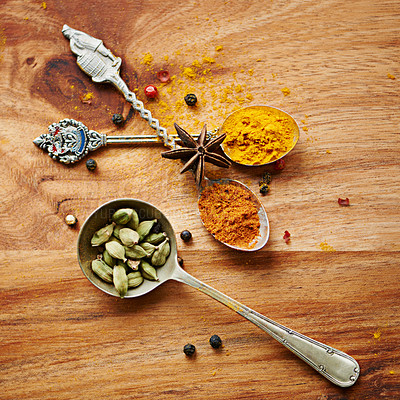 Buy stock photo Spoons, spice and selection of color for seasoning on kitchen table, turmeric and cardamom for meal. Top view, condiments and options for spicy cooking in Indian culture, nutmeg and food preparation