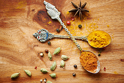 Buy stock photo Spoons, spice and selection of seasoning for health on kitchen table, turmeric and cardamom for meal. Top view, condiments and options for spicy gourmet in Indian culture, art and food preparation