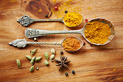 Buy stock photo Spoons, spice and selection of seasoning for gourmet on kitchen table, turmeric and cardamom for meal. Top view, cooking and options for spicy diet in Indian culture, art and food preparation