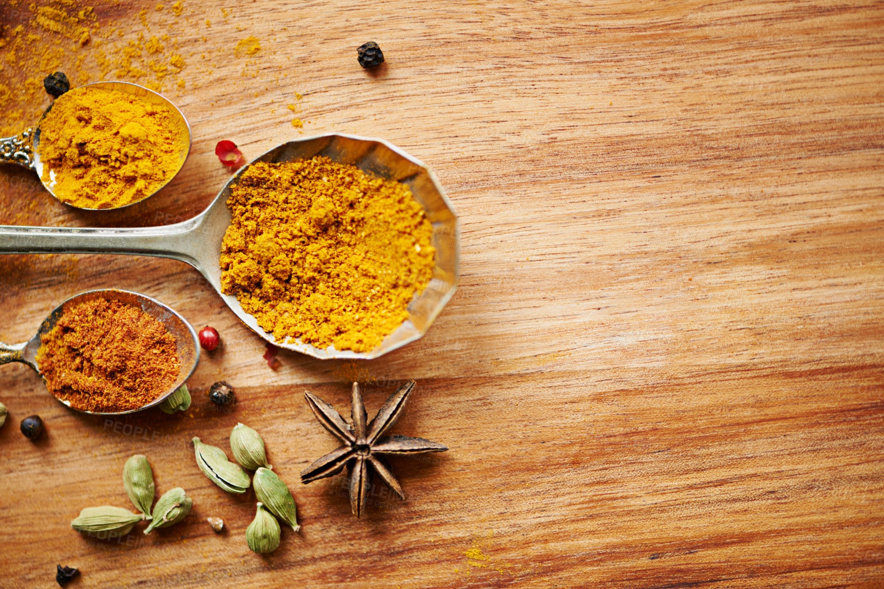 Buy stock photo Spoons, spice and selection of powder for diet on kitchen table, turmeric and cardamom for art. Top view, condiments and options for spicy cooking in Indian culture, mockup space and food preparation