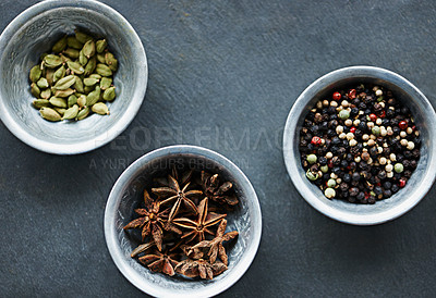 Buy stock photo Food, ingredients and spices in bowl on board for cooking Indian cuisine, meal and lunch. Flavour, culinary and seasoning for gourmet dinner with cardamon seeds, star anise and peppercorn