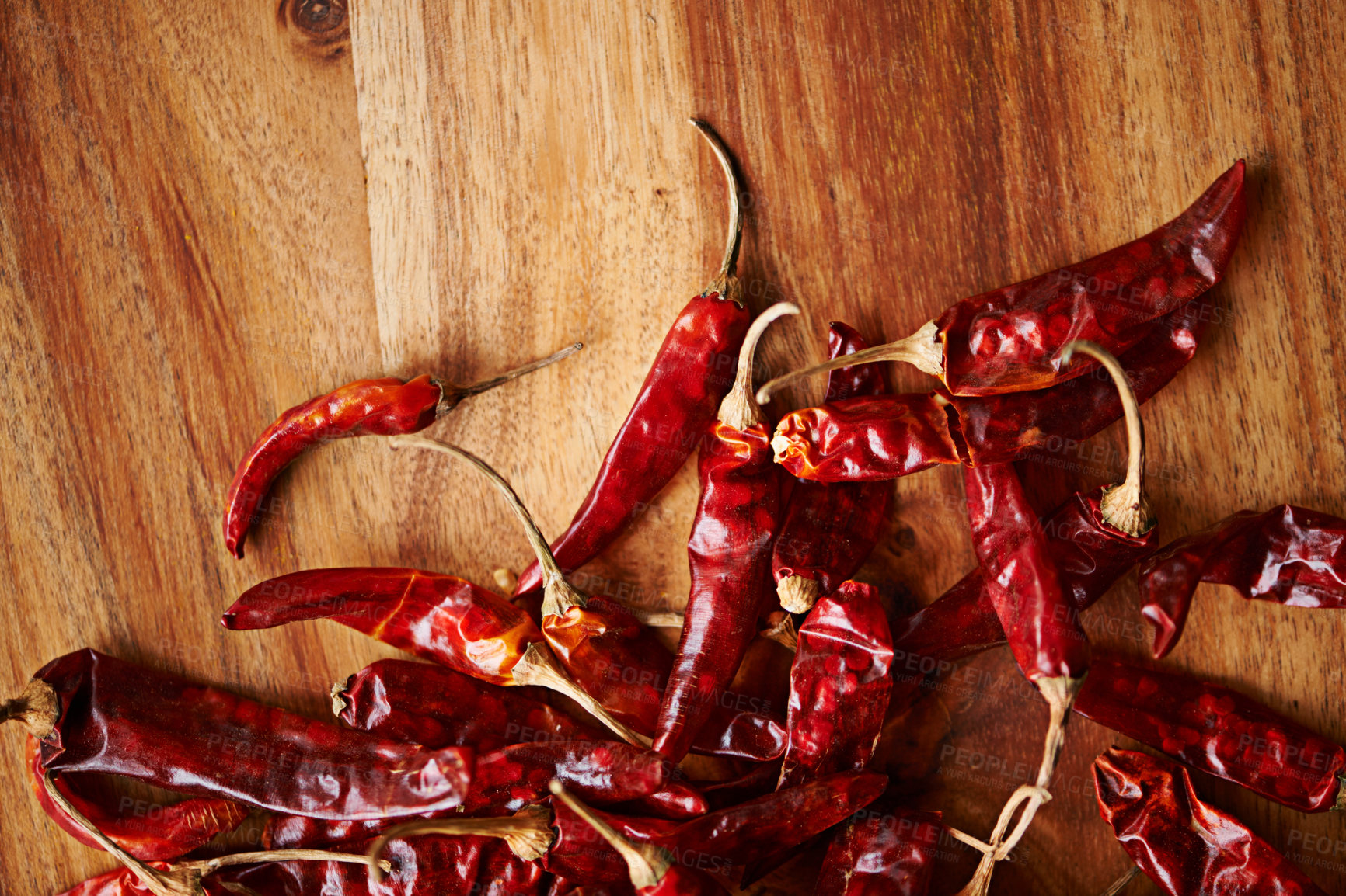 Buy stock photo Above, chilli and board for pepper, spices and flavor for dry ingredient for cooking, cuisine and food. Paprika, cayenne or condiment and spicy with red colour for capsicum and heat in dish or meal