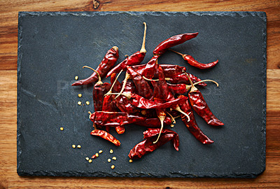 Buy stock photo Red, chilli and kitchen for pepper, spices and flavor for dry ingredient for cooking, cayenne or food. Paprika, background or above of condiment for vitamin c, lunch or dinner with fruit in home meal