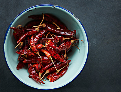 Buy stock photo Above, chilli and bowl for pepper, spices and flavor for dry ingredient for cooking, cuisine and food. Paprika, cayenne or condiment and spicy with red colour for capsicum and heat in dish or meal