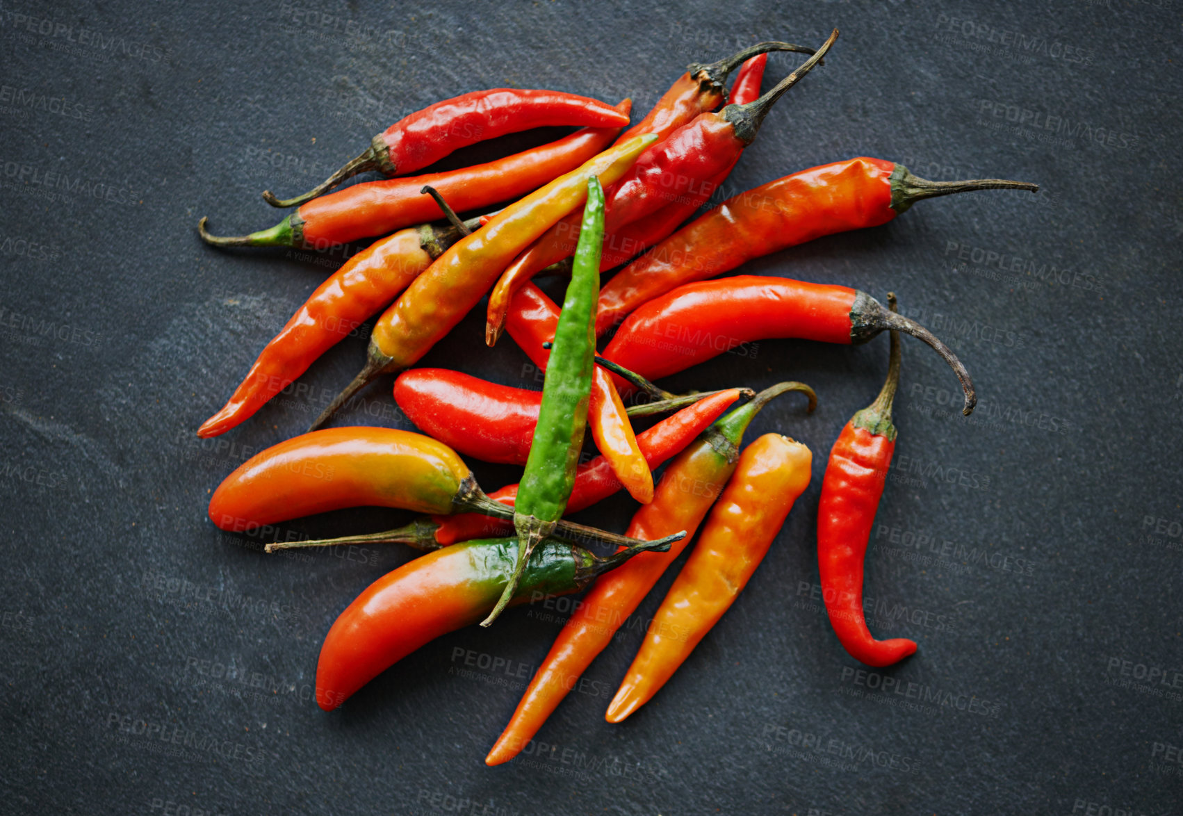 Buy stock photo Chilli, pepper and top view of vegetable for food, ingredient or spices for nutrition and flavor on dark background. Seasoning, heat and organic produce on counter top, fresh for cuisine and catering