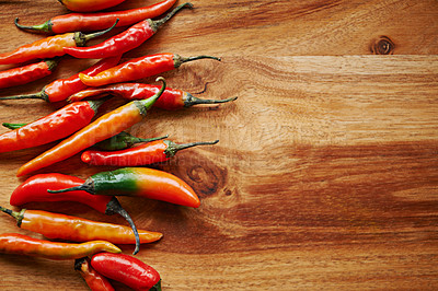 Buy stock photo Above, chilli or mockup background for food, spices and flavor for dry ingredient in cooking, cuisine or capsicum. Paprika, cayenne or condiment on wooden counter, board or spicy red pepper for meal
