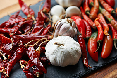 Buy stock photo Spices, chilli and garlic with vegetables for food, ingredients and culinary closeup for nutrition and flavor at home. Seasoning, heat and organic produce on table, fresh for cuisine and catering