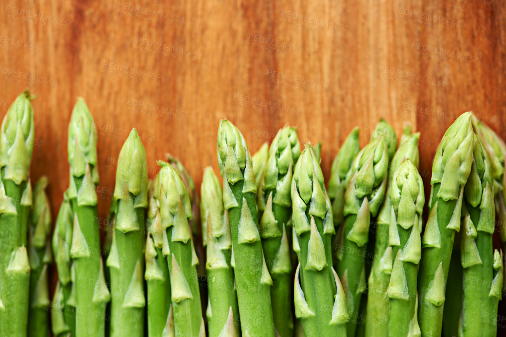 Buy stock photo Vegetables, asparagus and ingredients for food with mockup, meal prep in kitchen and green produce on wood table. Dinner, lunch and catering with healthy cuisine for diet, fresh and organic for vegan