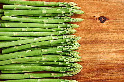 Buy stock photo Vegetables, asparagus mockup and food for diet, ingredients and prepare meal in kitchen with green produce on wood table. Dinner, lunch and catering with healthy cuisine, fresh and organic for vegan