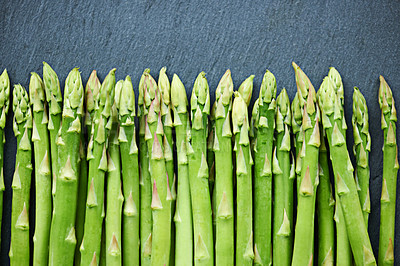 Buy stock photo Home, fresh asparagus or vegetables in kitchen for food or meal prep for salad, green ingredients or dinner. Raw, background or catering with healthy nutrition for vegan diet, lunch or organic bundle