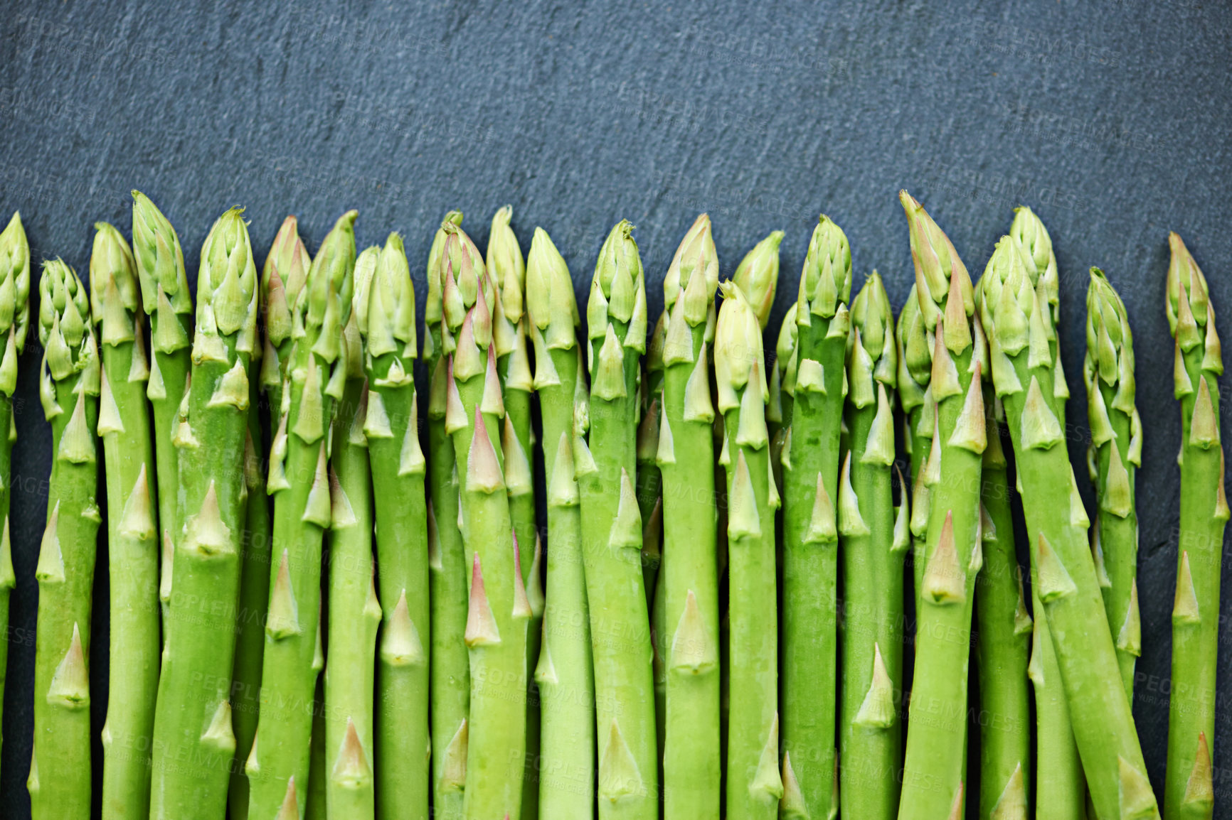 Buy stock photo Home, fresh asparagus or vegetables in kitchen for food or meal prep for salad, green ingredients or dinner. Raw, background or catering with healthy nutrition for vegan diet, lunch or organic bundle