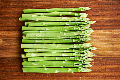 Buy stock photo Home, raw asparagus or vegetables in kitchen for food or meal prep for salad, green ingredients or dinner. Fresh, background or catering with healthy nutrition for vegan diet, lunch or organic bundle