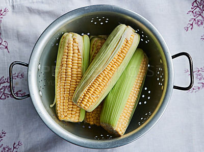 Buy stock photo Closeup, corn or maize on table for raw fruit, wellness or healthy nutrition in home meal or kitchen. Cobs, background or above of natural produce for organic food, fiber or vitamin b in lunch diet