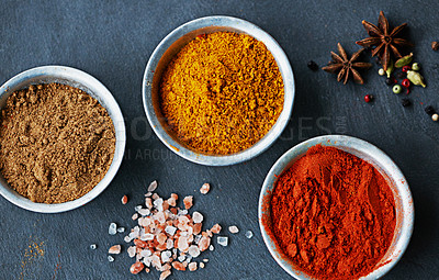 Buy stock photo Cropped shot of an assortment of colorful spices in bowls