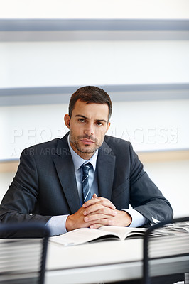 Buy stock photo Portrait, serious and male lawyer at desk with documents, evidence and research in office. Businessman, consultant and critical thinking at table for career, expertise and records in corporate firm