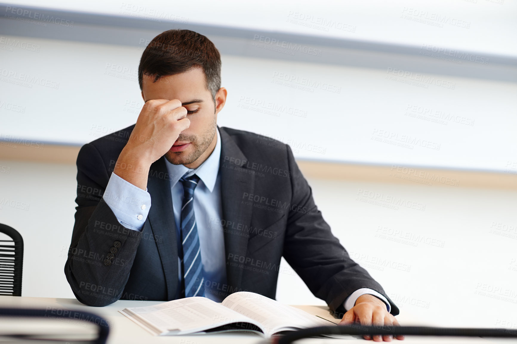 Buy stock photo Frustrated businessman, headache and paperwork with stress in anxiety, fatigue or debt at office. Young man, accountant or employee with migraine in depression, bankruptcy or financial crisis at desk