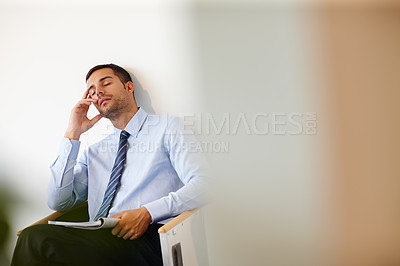 Buy stock photo Businessman, tired and magazine in waiting room with burnout for job, meeting and appointment in office. Accountant, headache and stress or mental health for stock market or economy with mockup 