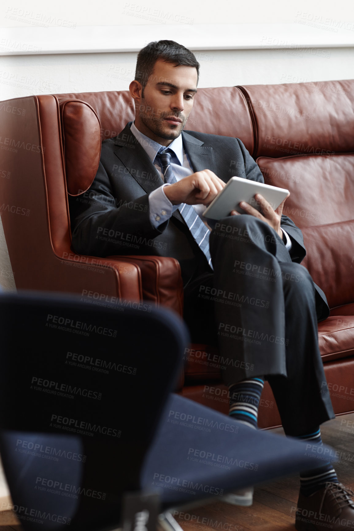 Buy stock photo Businessman, reading and tablet on couch for online, research and email in waiting room. Trader, stock market and internet with technology for planning and proposal for international company