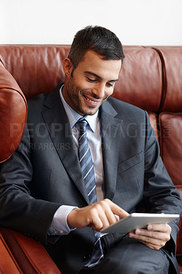 Buy stock photo Business, tablet and man on couch, typing and smile for internet, connection and reading news. Person, employee and consultant on sofa, tech and website info with online chatting, texting and message