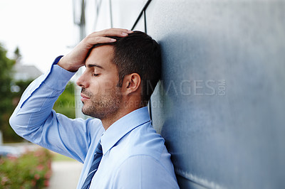 Buy stock photo A businessman stressed about financial debt, taking a break. 
Overworked male entrepreneur frustrated or disappointed. Corporate man with anxiety. Businessperson with a migraine or a headache