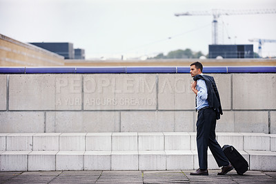 Buy stock photo Serious, businessman and walking with suitcase for morning journey or commute to work on urban street. Worry, male person or employee and travel to law firm with luggage and suit on city sidewalk