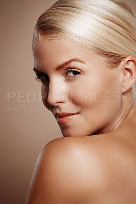 Buy stock photo Beauty shot of a young blonde woman looking over her shoulder