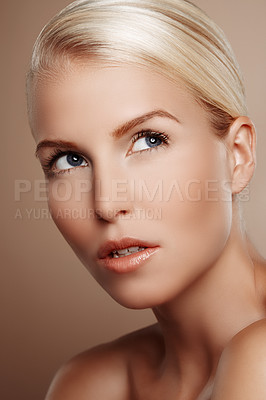 Buy stock photo Beauty shot of a young blonde woman looking up