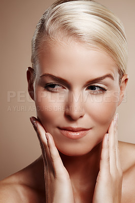 Buy stock photo Beauty shot of a young blond woman touching her face
