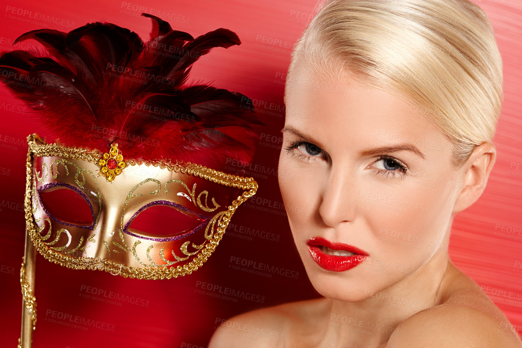 Buy stock photo Portrait, confidence and woman in carnival mask for beauty, art deco and dress up by red background. Cosmetics, female person and mysterious or playful with fantasy, lipstick and cosplay in studio 