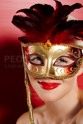 Buy stock photo Portrait, happy and woman in carnival mask for fun, art deco and dress up by red background. Smile, pride and female person with mysterious or playful look for cosplay in studio with lipstick