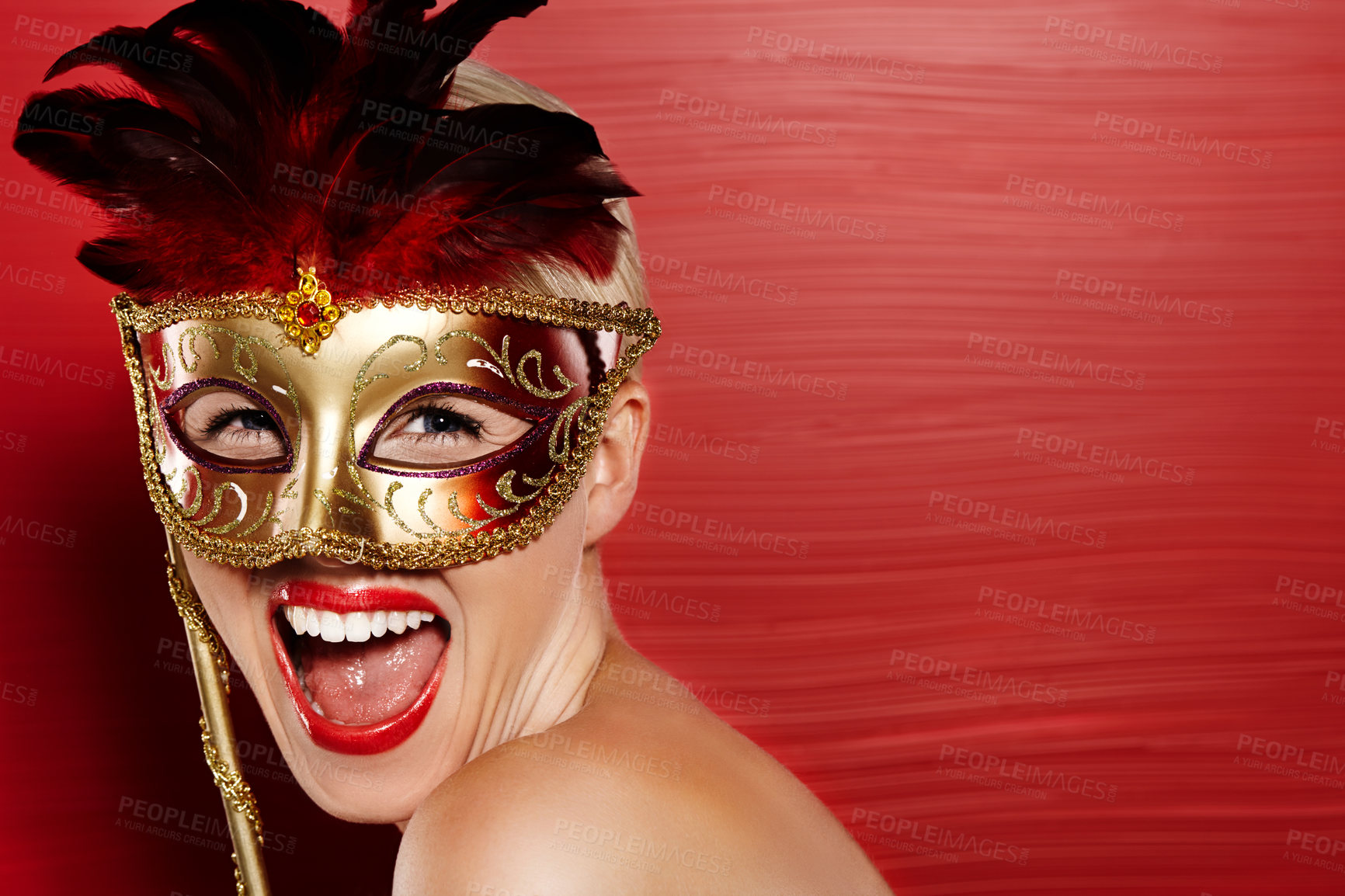 Buy stock photo Portrait, excited and woman in carnival mask for fun, art deco and dress up by red background. Happiness, female person and mysterious or playful with wow emoji for mockup in studio with lipstick