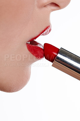 Buy stock photo Closeup studio shot of a woman applying red lipstick isolated on whtie